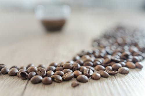 Free Coffee Beans on Wooden Surface Stock Photo