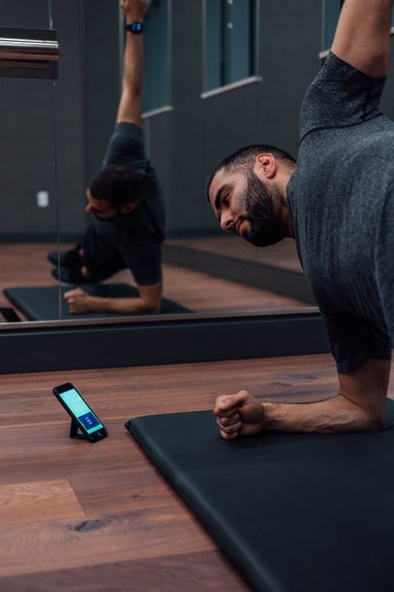 A smartphone camera using computer vision fitness technology to analyze a user's squat form.