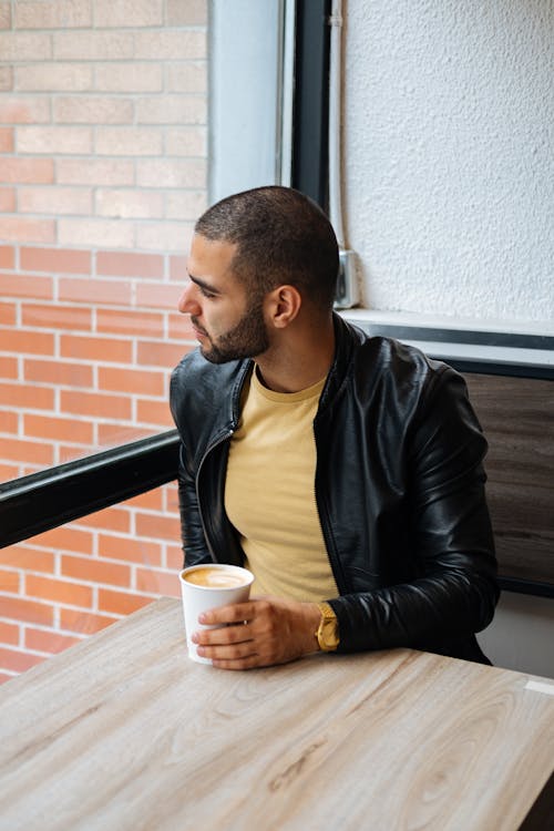 Free Man in Black Leather Jacket Holding a Disposable Cup Stock Photo