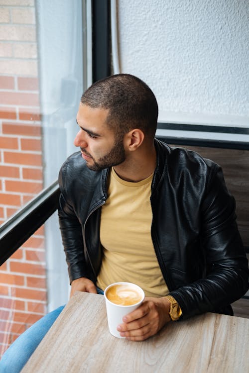 Free Man in Black Leather Jacket Holding Holding a Cup of Coffee Stock Photo