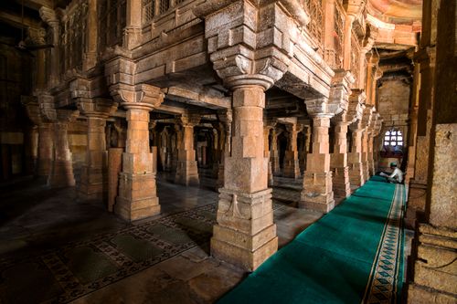 Free Explore the exquisite stone architecture of Ahmadabad's Jami Mosque with its intricate pillars and serene atmosphere. Stock Photo