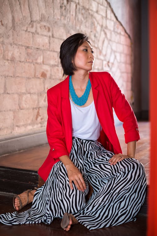 Woman in Red Blazer Sitting on the Floor