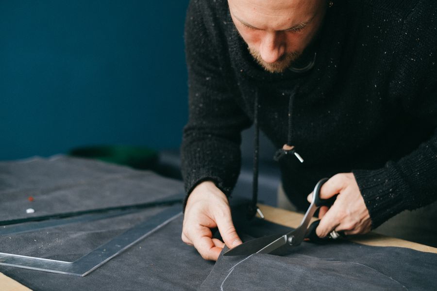 Leather product cutting and preparation at a workshop table