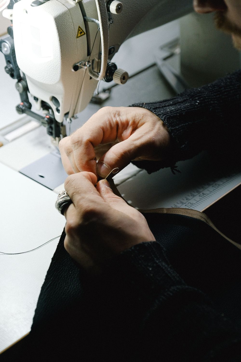 Tailor taking in a garment at the sewing machine