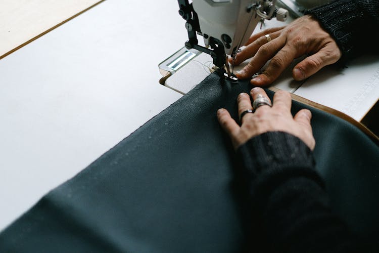 Close Up Of Woman Hands Sewing Fabric