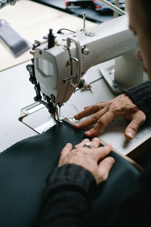Close-up of hands sewing fabric on a machine