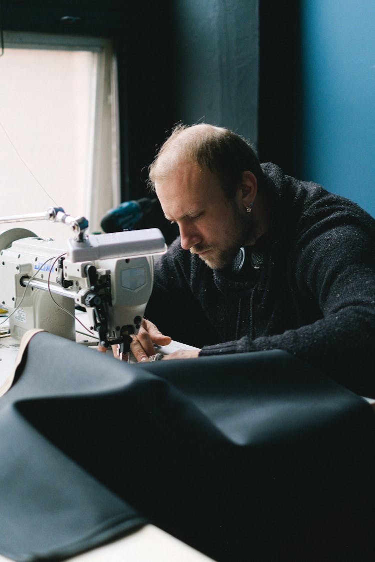 Man Sewing On Machine