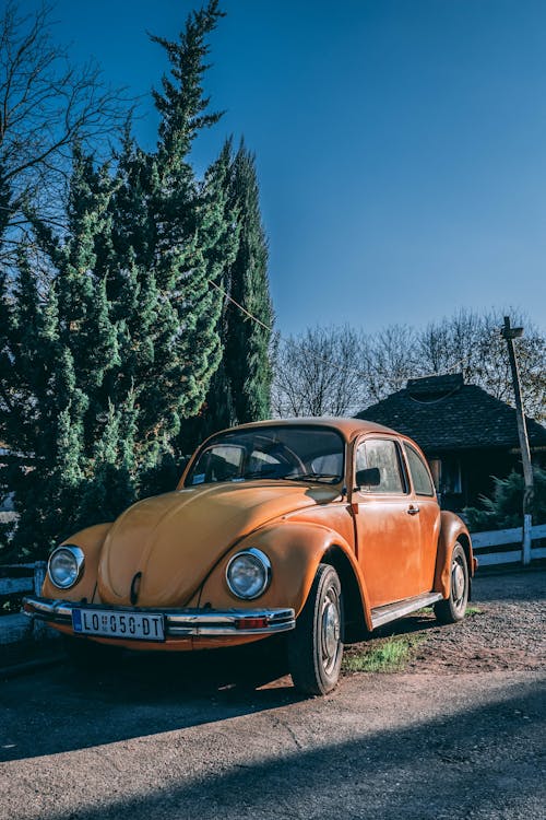 Free Brown Classic Car Parked Near Green Trees Stock Photo