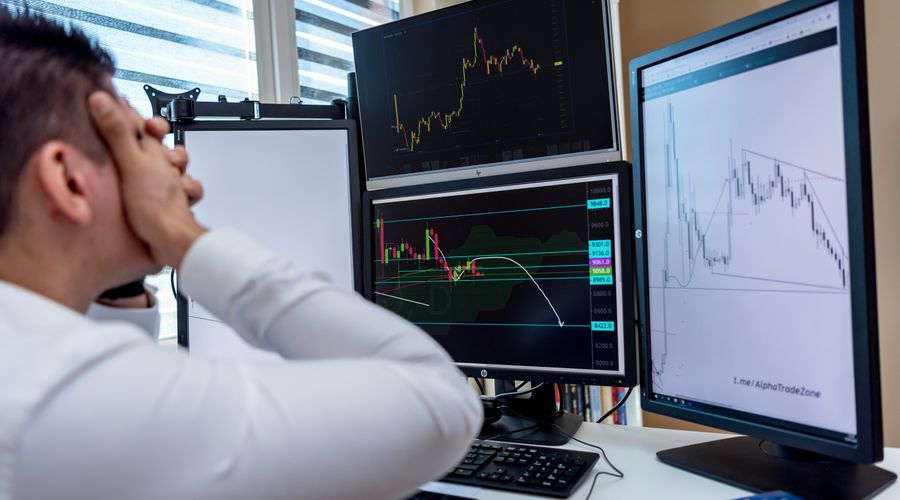 Frustrated trader monitoring multiple trading screens with financial charts, illustrating the psychological pressure of scalping
