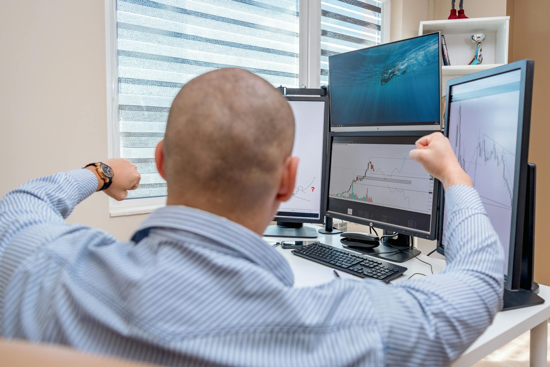 A Man Sitting on the Work Desk with Computer