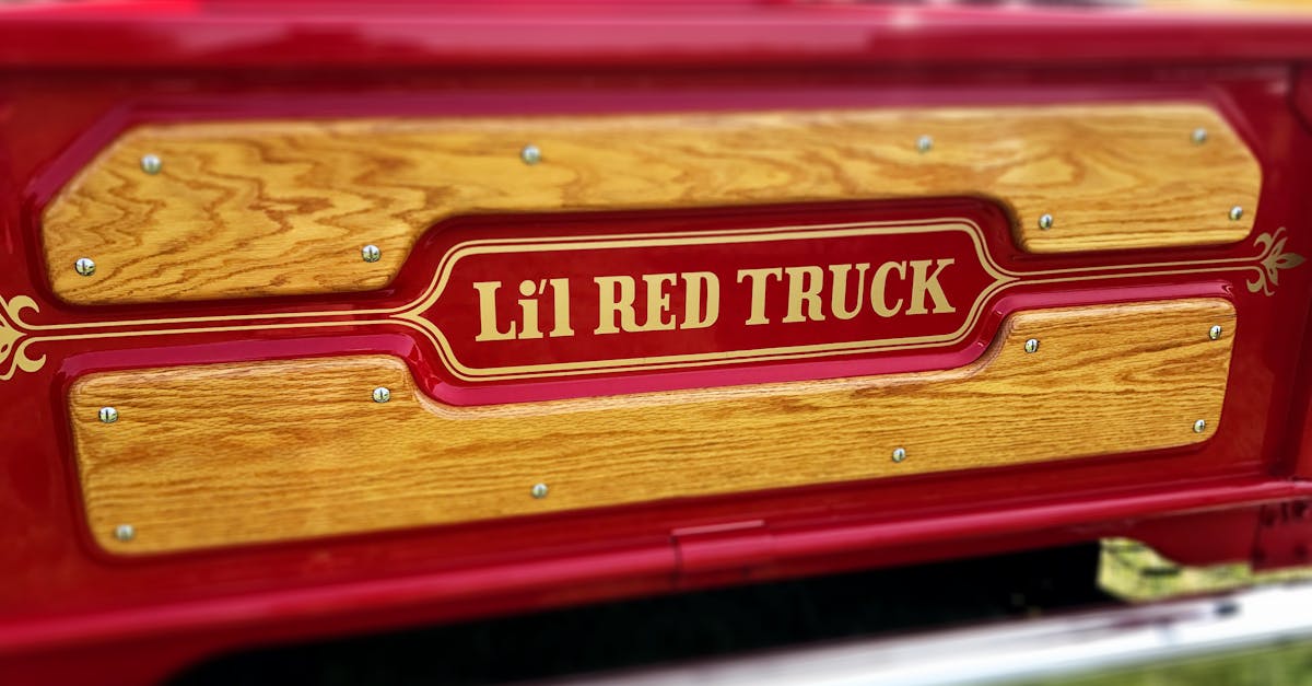 Selective Focus Photography of Lel Red Truck Tailgate Sign