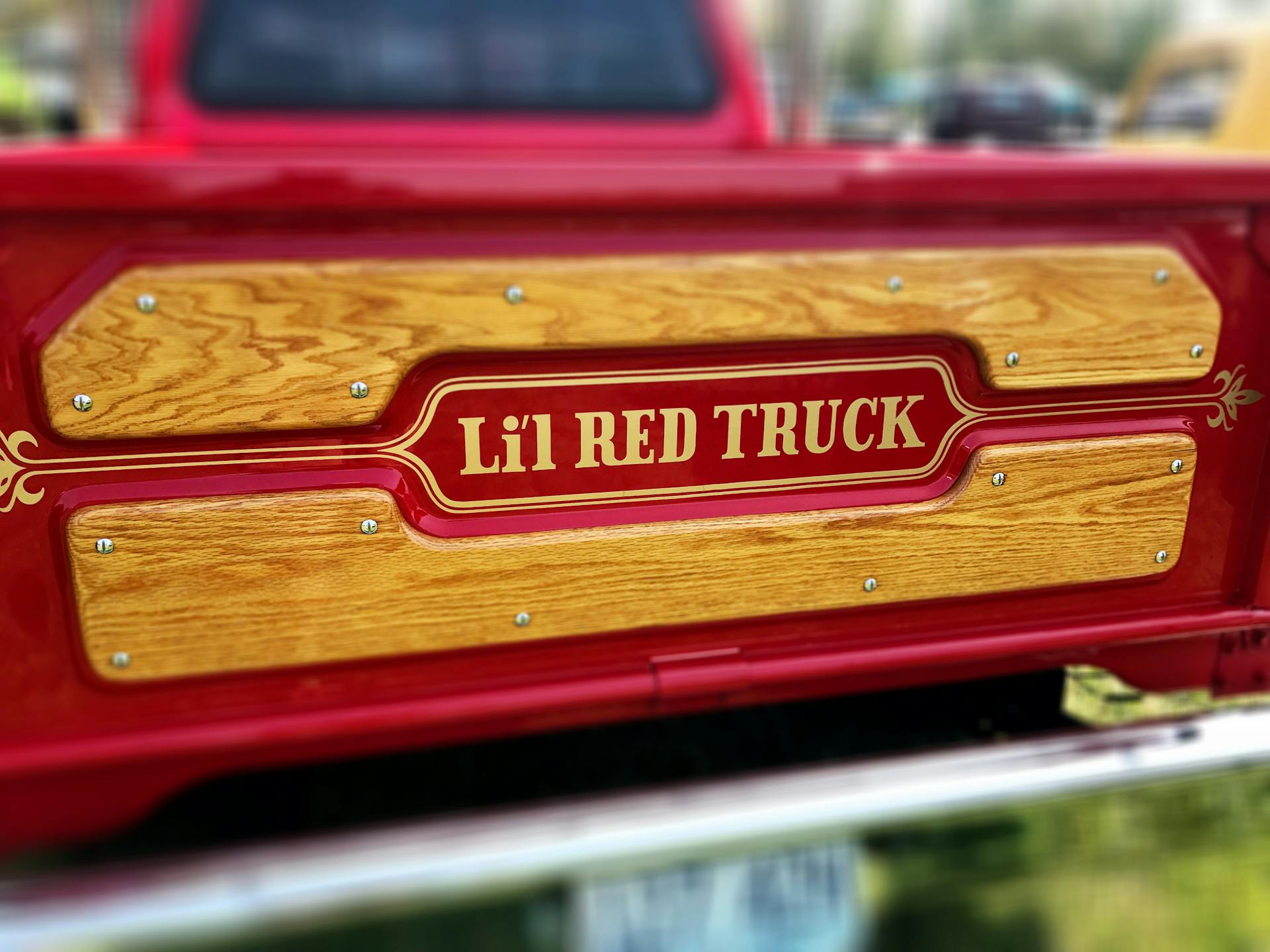 Selective Focus Photography of Lel Red Truck Tailgate Sign