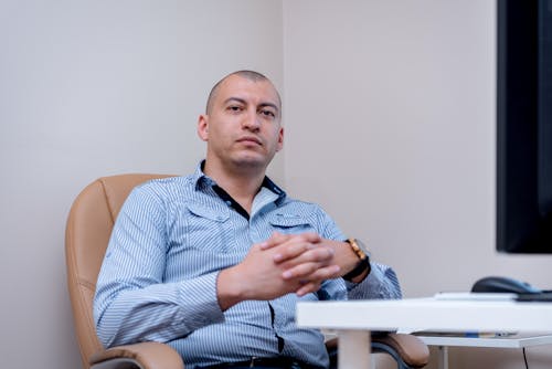 Man Sitting on a Chair in the Office