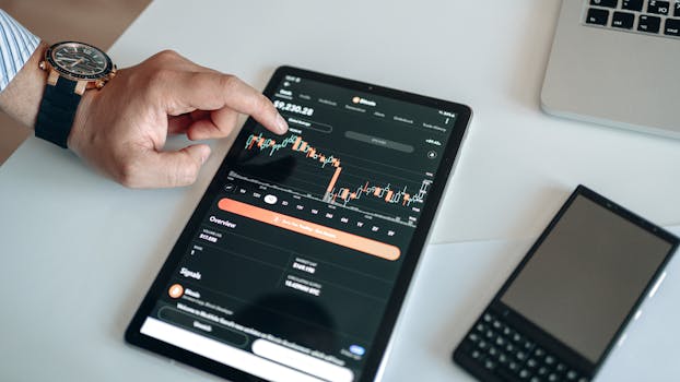 A person using a tablet to view and analyze a cryptocurrency market chart indoors.