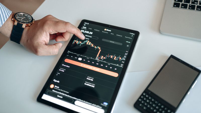 A tablet displaying a live crypto market chart — photo by AlphaTradeZone on Pexels