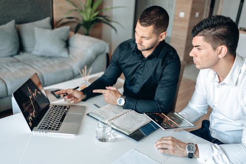 Free Men Having Meeting Using a Laptop and a Digital Tablet Stock Photo