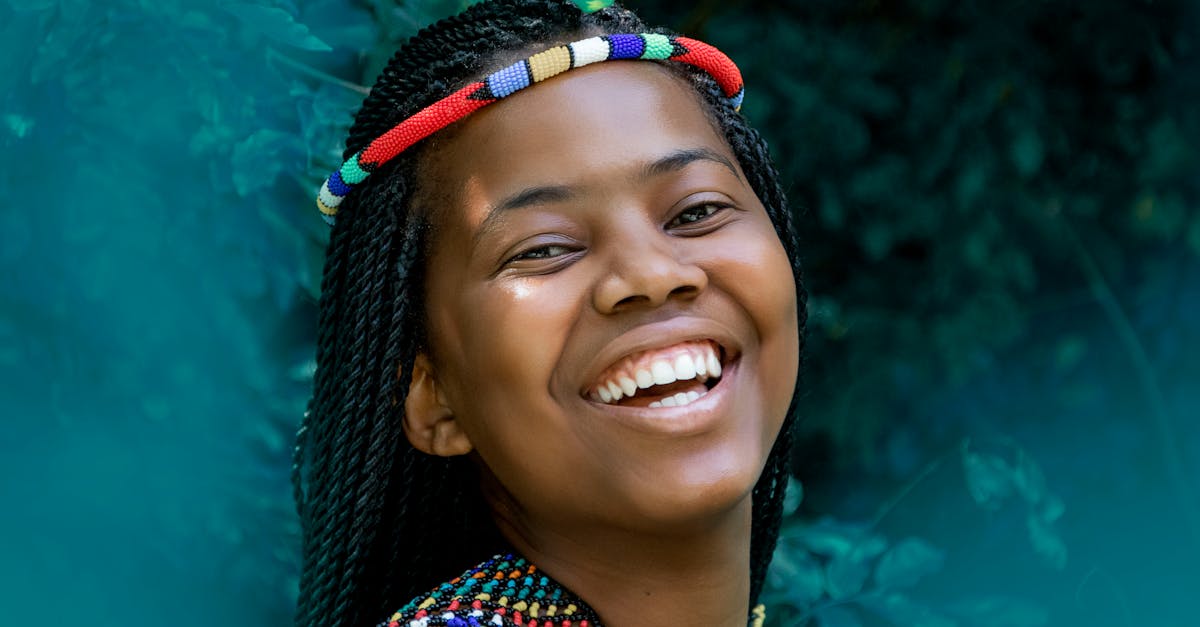 Joyful portrait of a smiling woman in South Africa with vibrant beadwork.