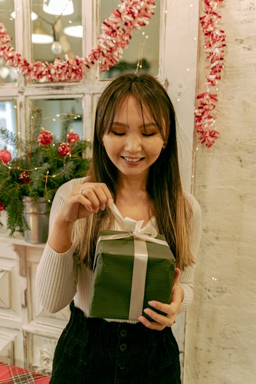 Woman Holding a Green Gift Box