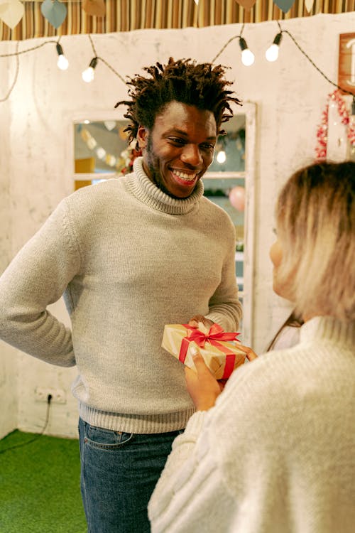 Free A Man in Gray Knitted Jacket Receiving a Gift Stock Photo