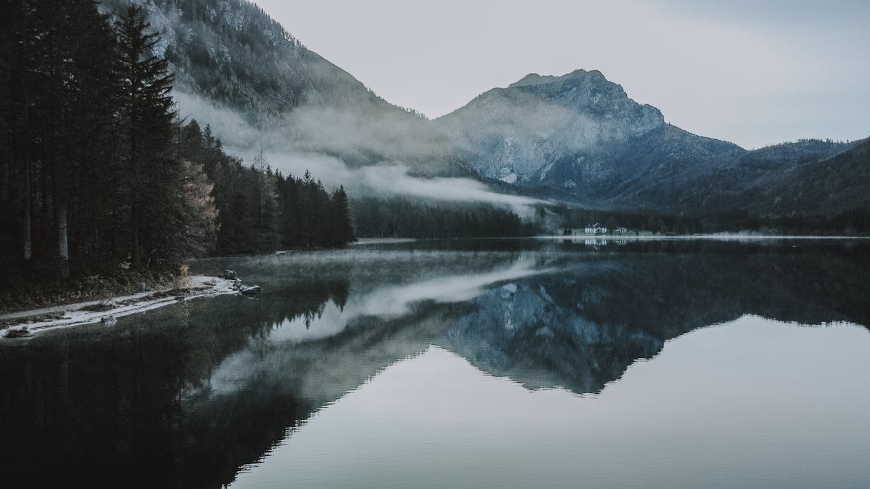 Rocky mountains behind lake and trees