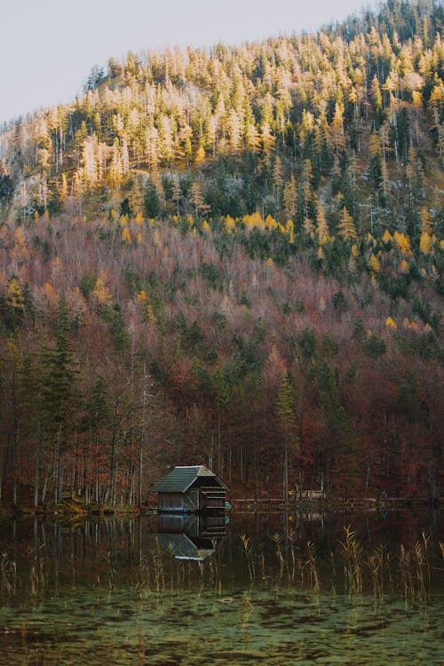 Small house on lake in mountains