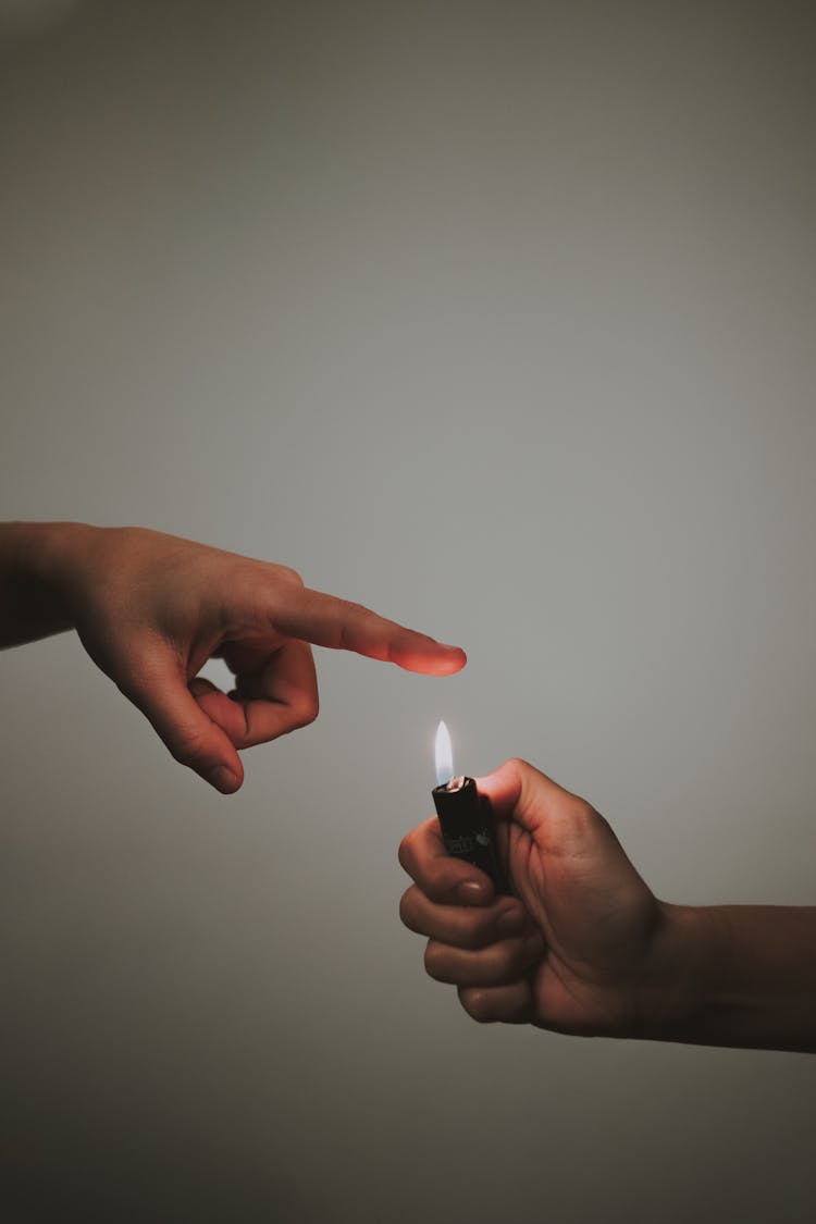 Crop Person With Lighter In Studio