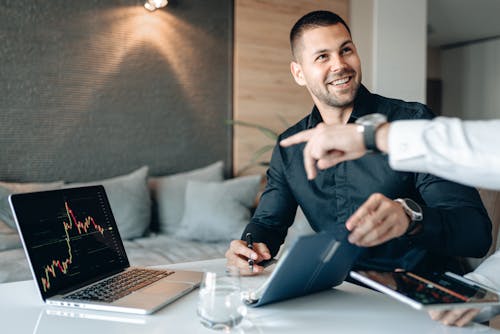 Free A Man in Black Long Sleeves Shirt Holding a Pen and a Notebook Stock Photo