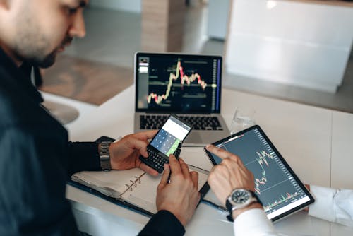 A Man Calculating using Smartphone 