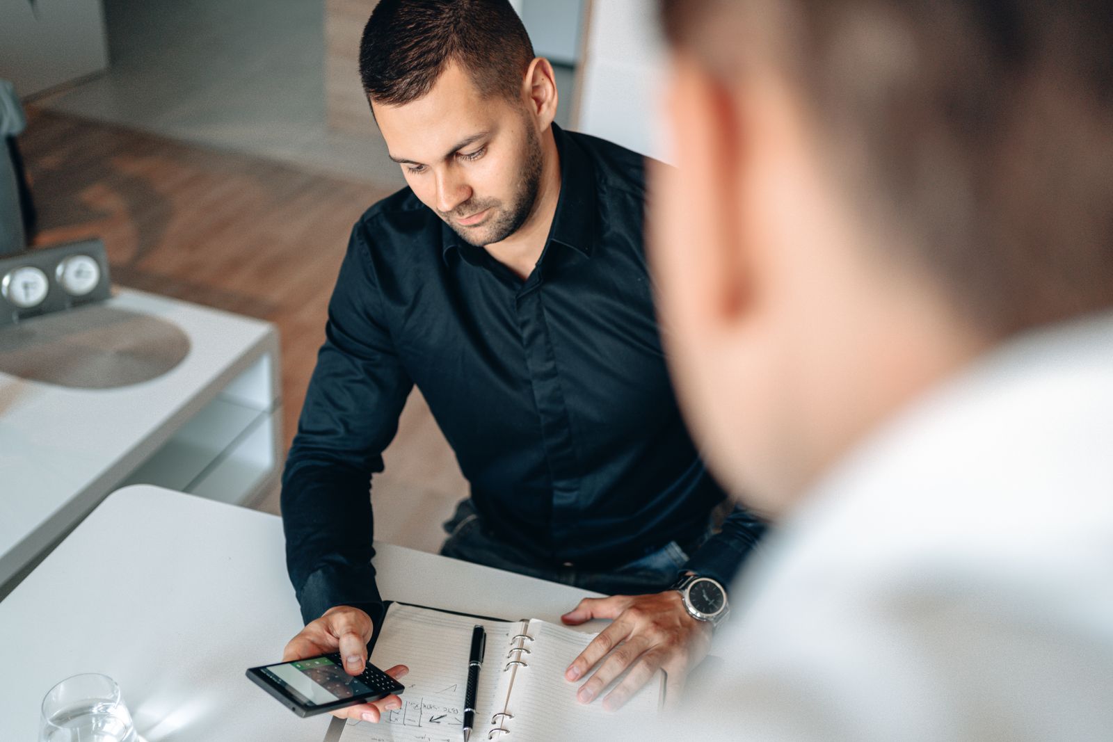 Roofing office manager reviewing job costs with a calculator