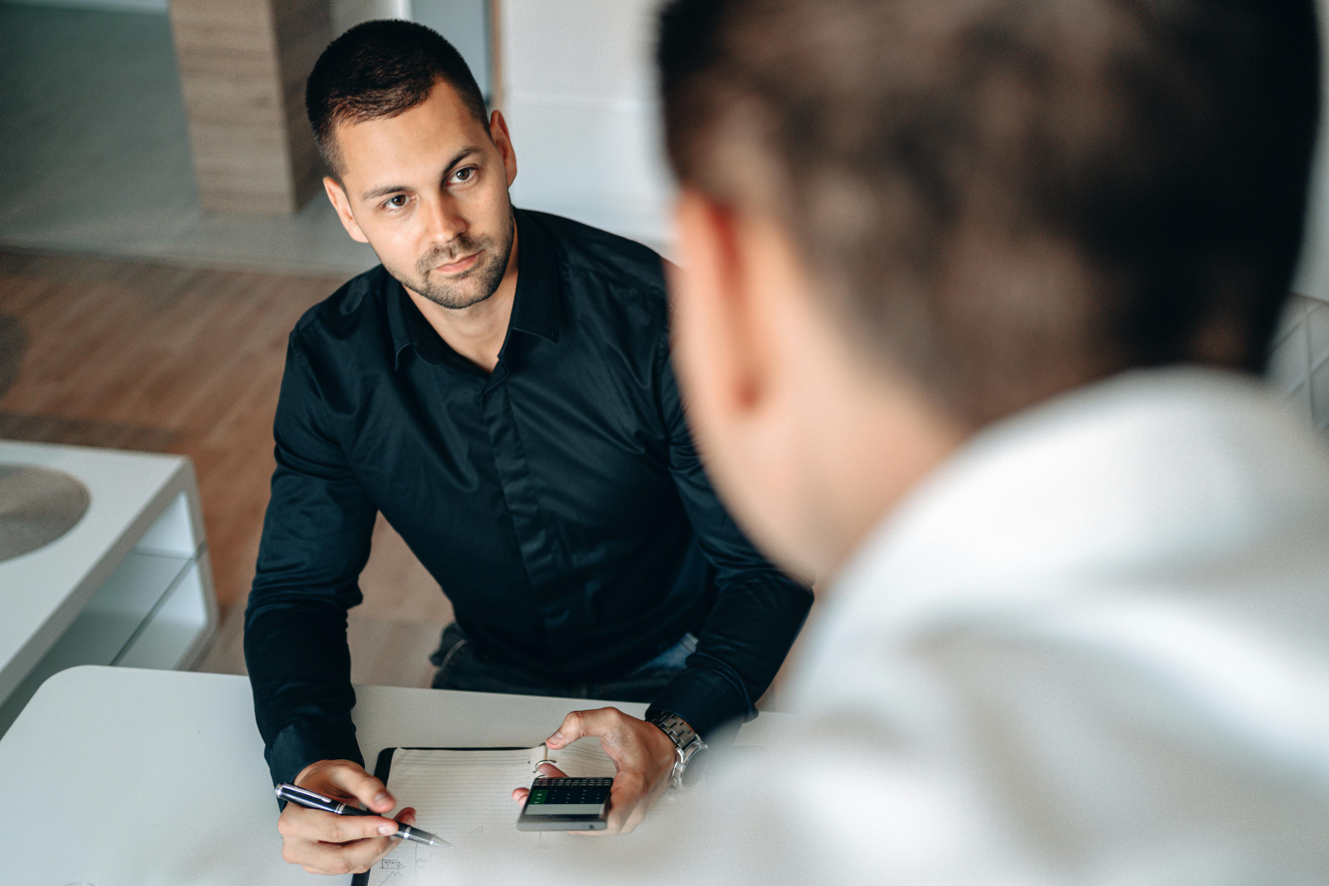 Men collaborating in an office setting, focused on planning and strategy.