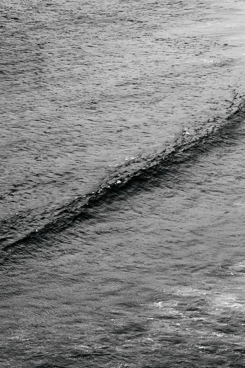 Free From above of black and white wave of rippling sea on sunny day Stock Photo