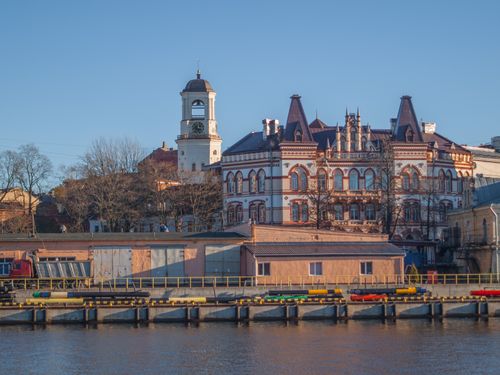 Free A beautifully preserved historic building next to a river in Vyborg, showcasing ornate architecture. Stock Photo