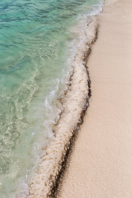 Tropical sea with sandy shore in sunlight