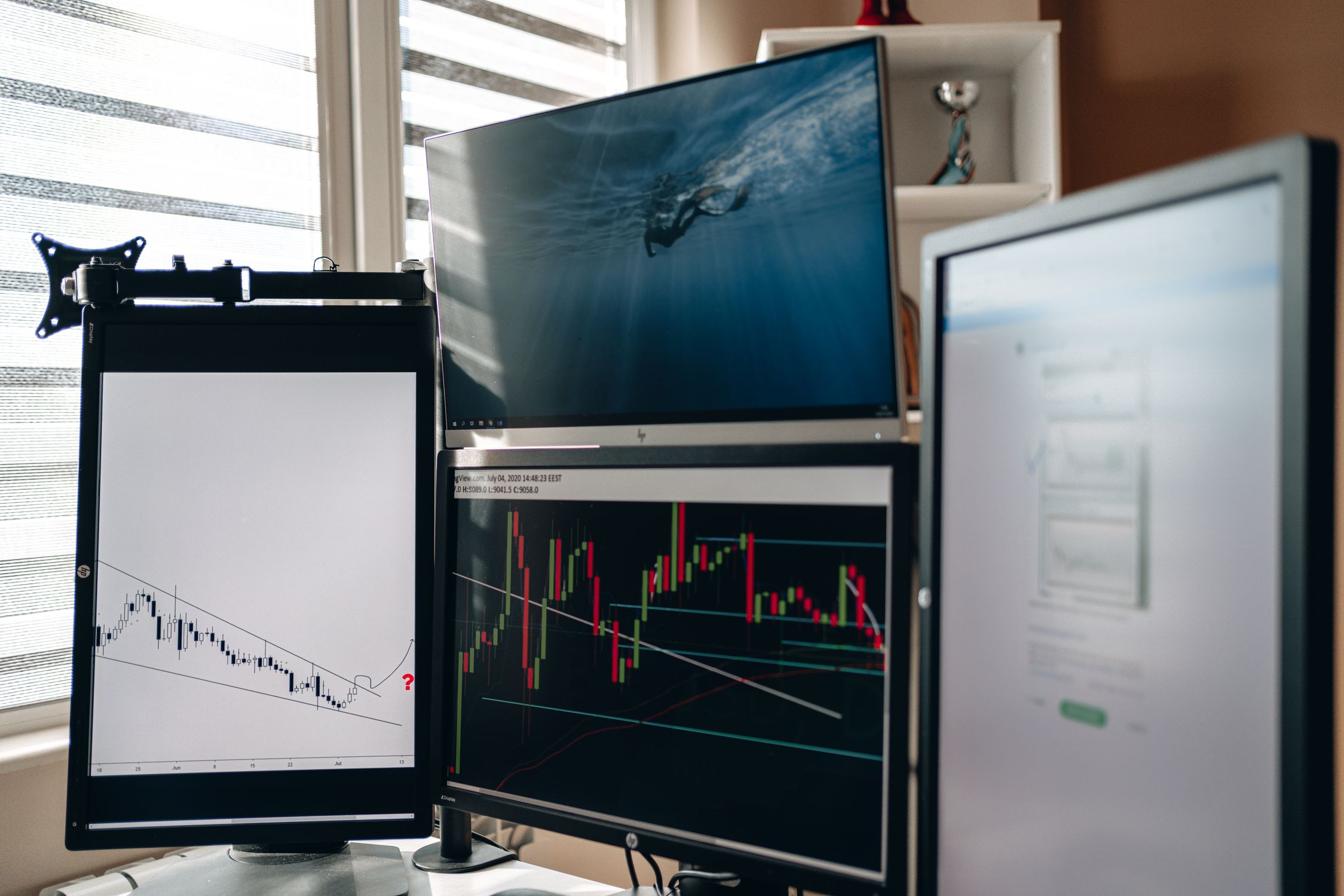 Multiple trading screens displaying algorithmic trading data and forex charts