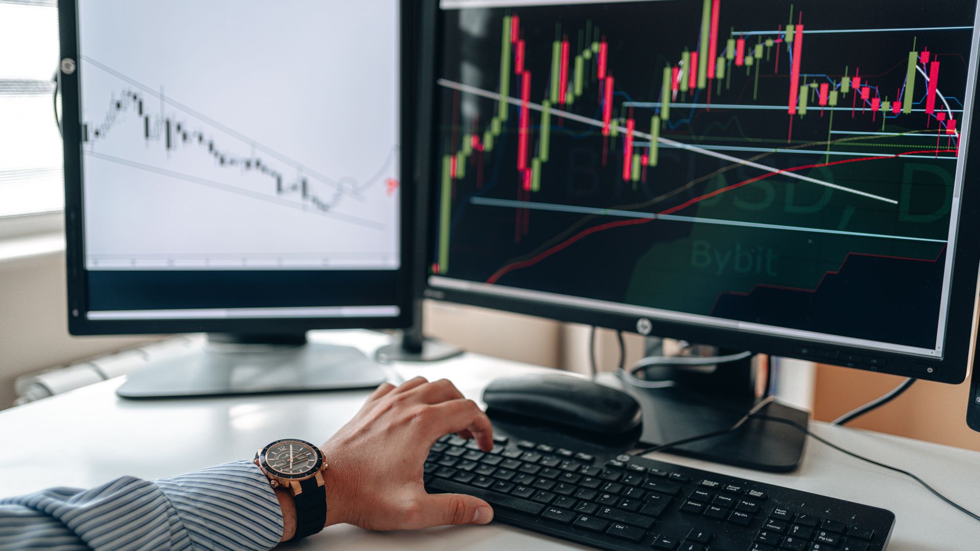 Trader reviewing financial charts and data on a computer