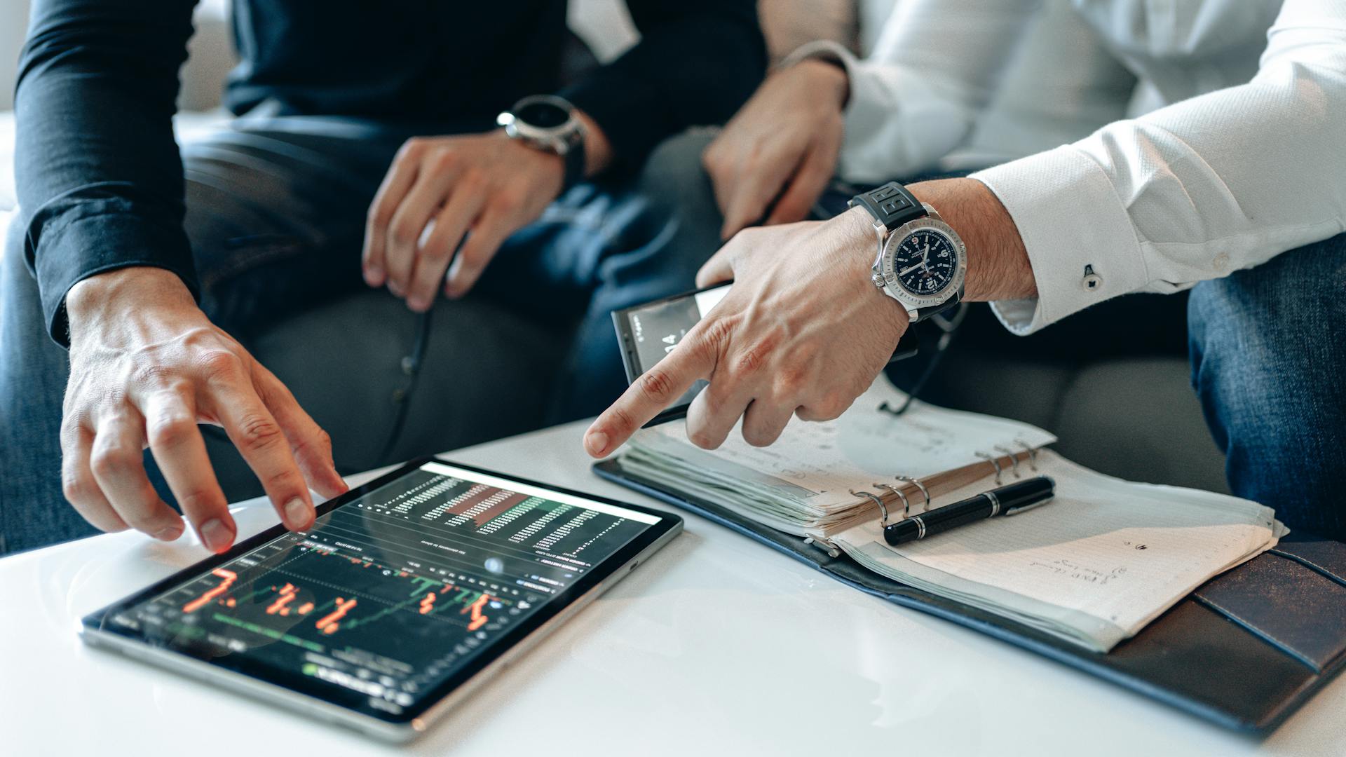 Traders Wearing Wristwatch Pointing the Screen of the Tablet with Crypto Graph