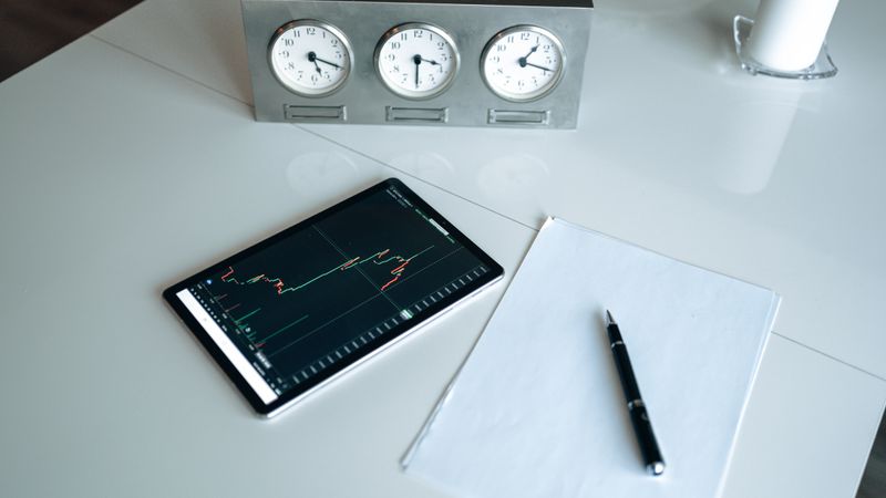 Tablet showing a candlestick chart on a desk — photo by AlphaTradeZone on Pexels