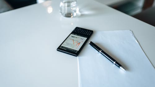 Free Black Smartphone with Graph on Screen Stock Photo
