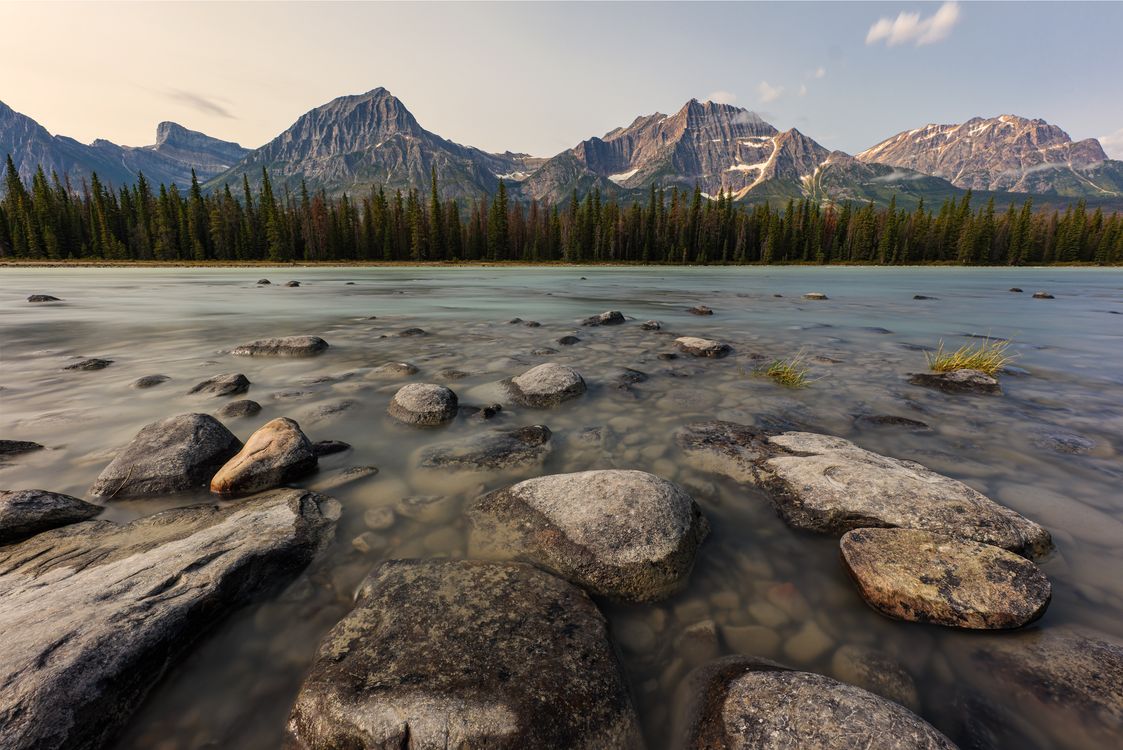 Rocky river scene with prominent mountains in the foreground - a picturesque view of Jasper National Park, Canada