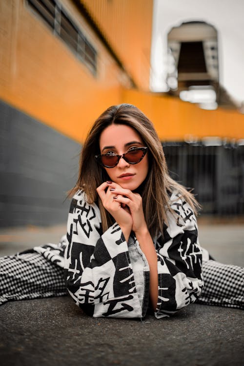 Free A Woman in White and Black Clothing Wearing Sunglasses Stock Photo