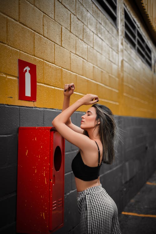 Beautiful Woman Posing on a Fire Extinguisher