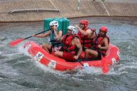 2 Men Riding Red Inflatable Boat on Water