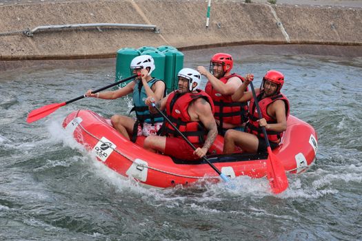 Group of men enjoying an exhilarating whitewater rafting adventure on a river.