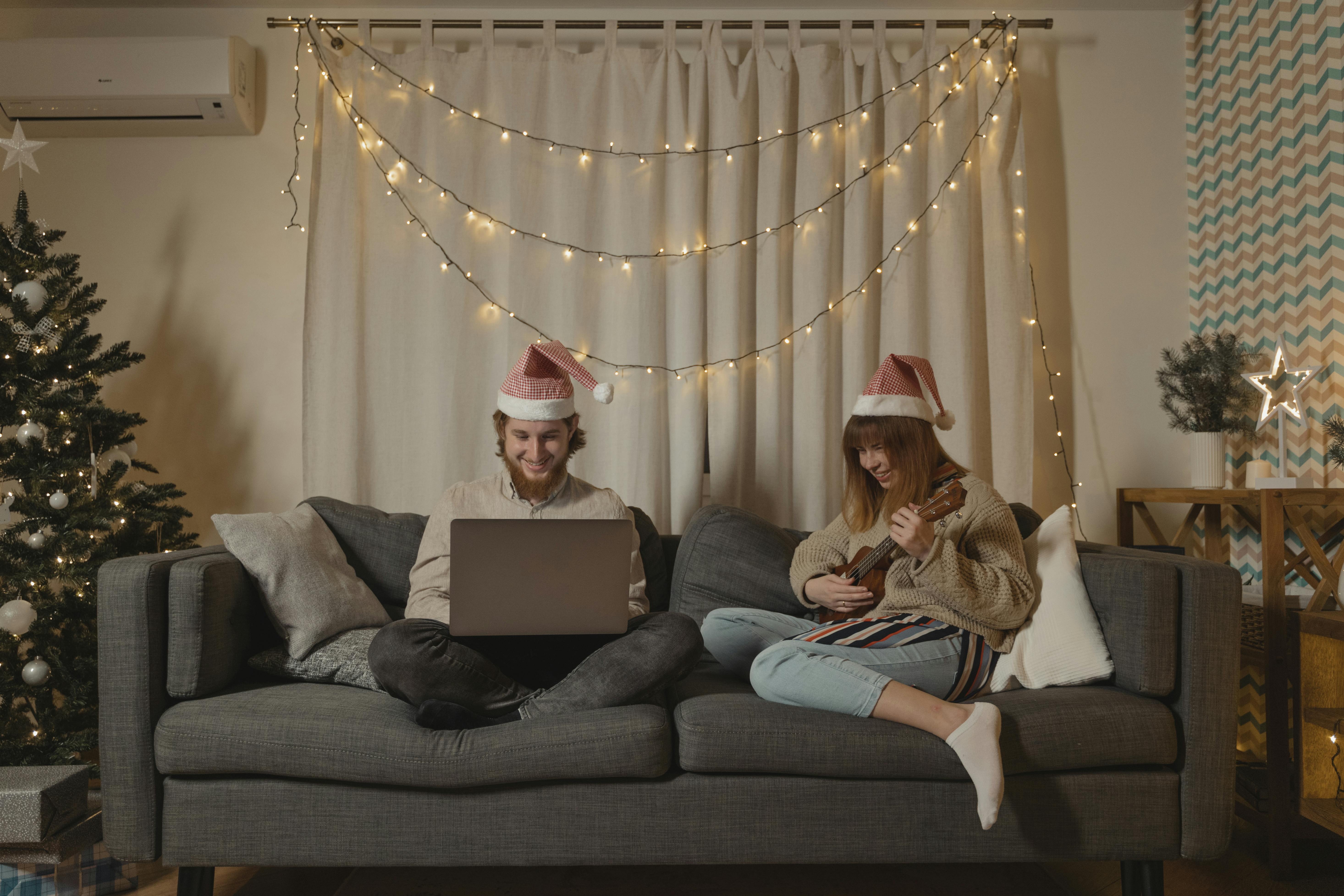 man and woman sitting on gray couch