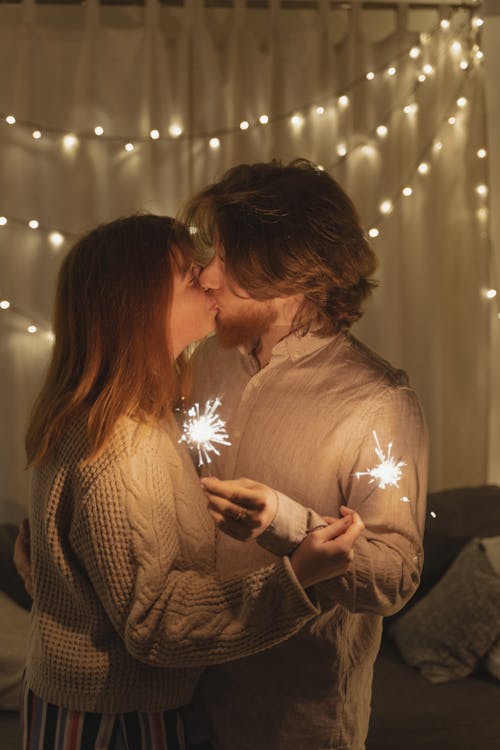 Man and Woman Kissing With Fireworks