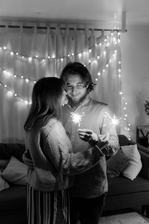 Monochrome Photo of a Couple Holding Sparklers