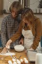 Man and Woman Holding White Ceramic Bowl