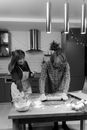 Grayscale Photo of Woman in Plaid Long Sleeve Shirt Sitting Beside Woman in Long Sleeve Shirt