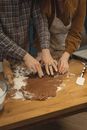 Person in Blue and White Plaid Dress Shirt Holding Brown Wooden Chopping Board