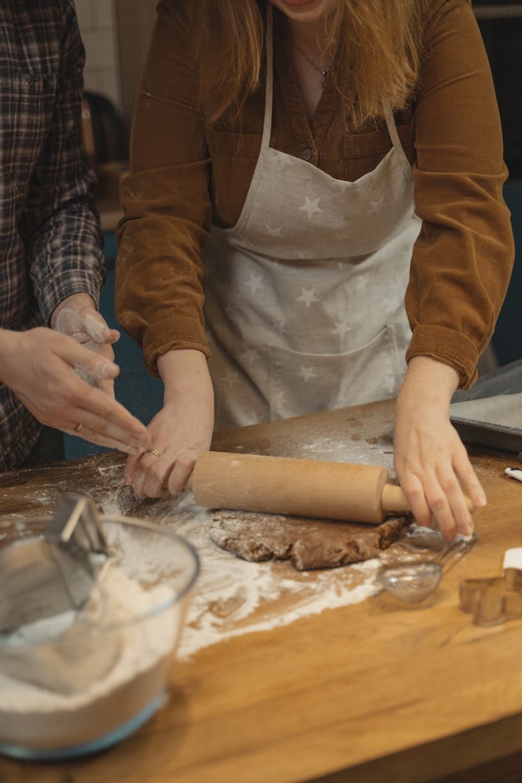 Person Flattening Dough With Rolling Pin